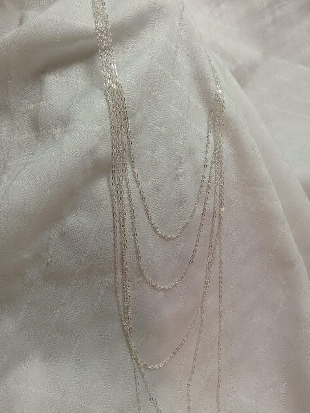 Handmade fashion nacklace with many chain rows in a silver color
